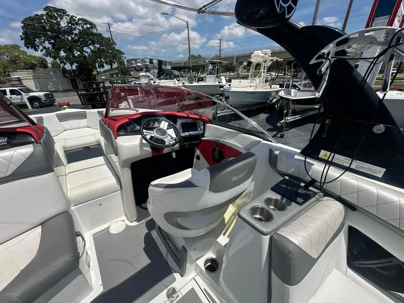 Slide: The Image of 2015 Tigé Z3 boat interior with steering wheel, seating, and cup holders. - 6