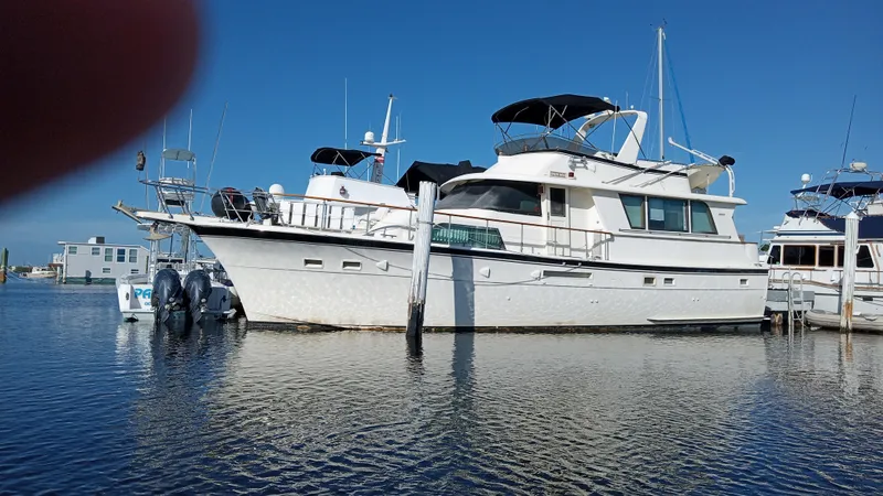 The Image of 1986 Hatteras 53 Extended Deckhouse Motor Yacht docked in a marina. - 0