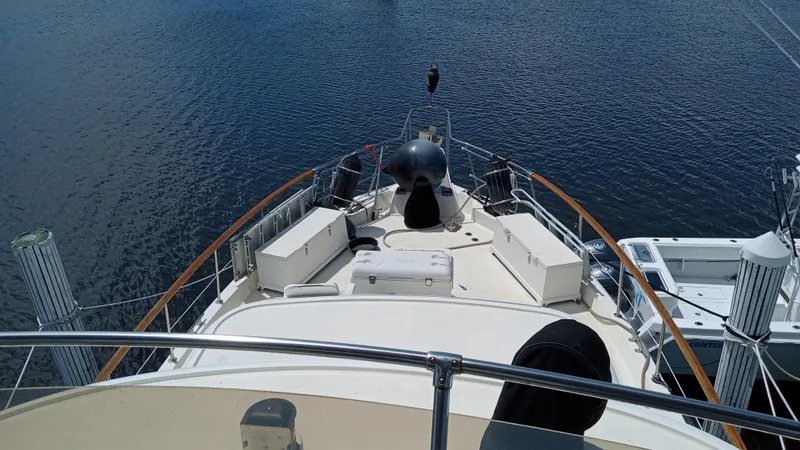 Slide: The Image of 1986 Hatteras 53 Extended Deckhouse Motor Yacht bow view on calm water. - 14