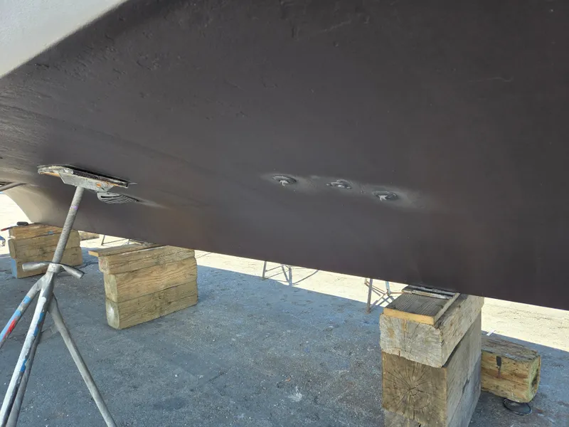 Slide: The Image of 1986 Hatteras 53 Extended Deckhouse hull on blocks, under maintenance. - 23