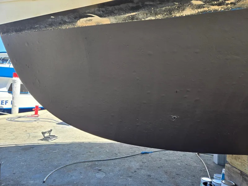 Slide: The Image of Bottom view of a 1986 Hatteras 53 Extended Deckhouse hull on dry dock. - 24