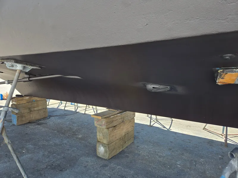 Slide: The Image of 1986 Hatteras 53 Extended Deckhouse hull on blocks, under maintenance. - 27