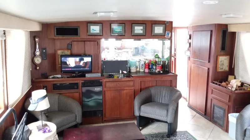 Slide: The Image of Interior of 1986 Hatteras 53 Extended Deckhouse Motor Yacht with cozy seating and entertainment area. - 3