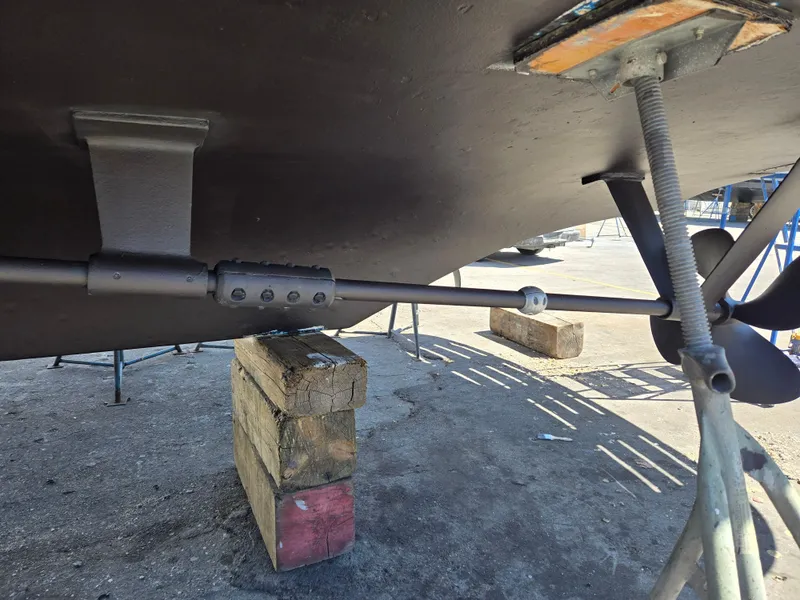 Slide: The Image of Bottom view of a 1986 Hatteras 53 Extended Deckhouse, showing propeller and support blocks. - 31