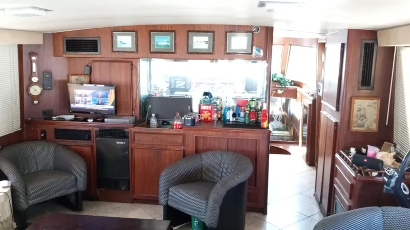Slide: The Image of Interior of 1986 Hatteras 53 Extended Deckhouse Motor Yacht with cozy seating and entertainment area. - 4