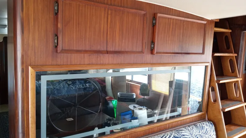 Slide: The Image of Interior of 1986 Hatteras 53 Extended Deckhouse Motor Yacht with wooden cabinets and window. - 6