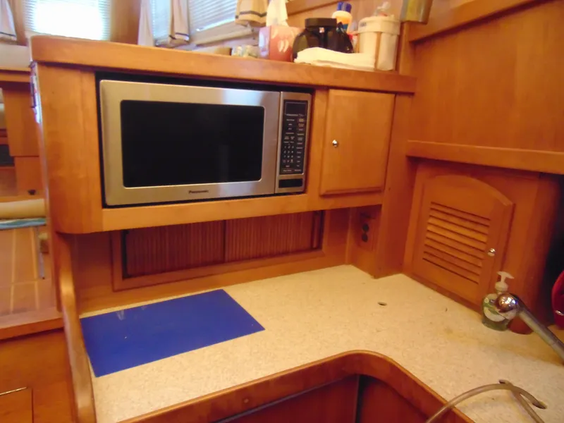 Slide: The Image of 2004 Sabre 36 Flybridge kitchen with microwave and countertop. - 10