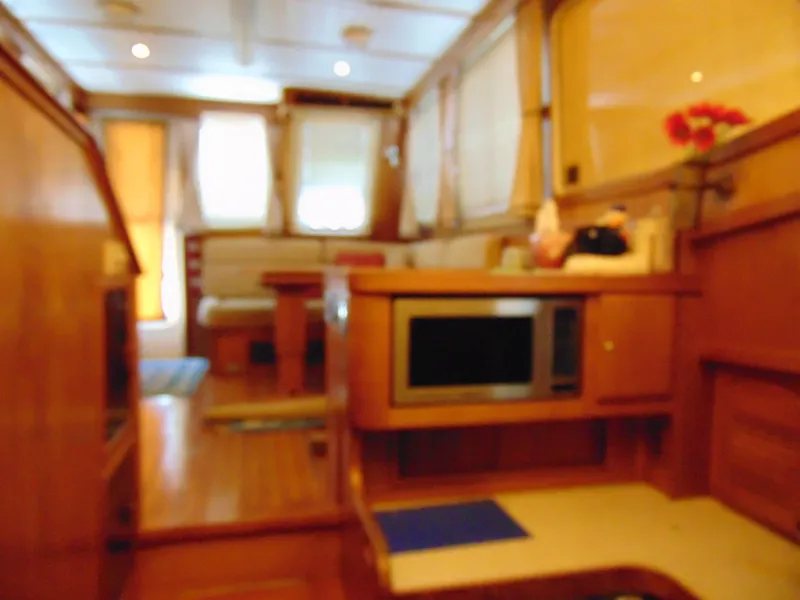 Slide: The Image of Interior of 2004 Sabre 36 Flybridge yacht with wooden furnishings and modern amenities. - 13