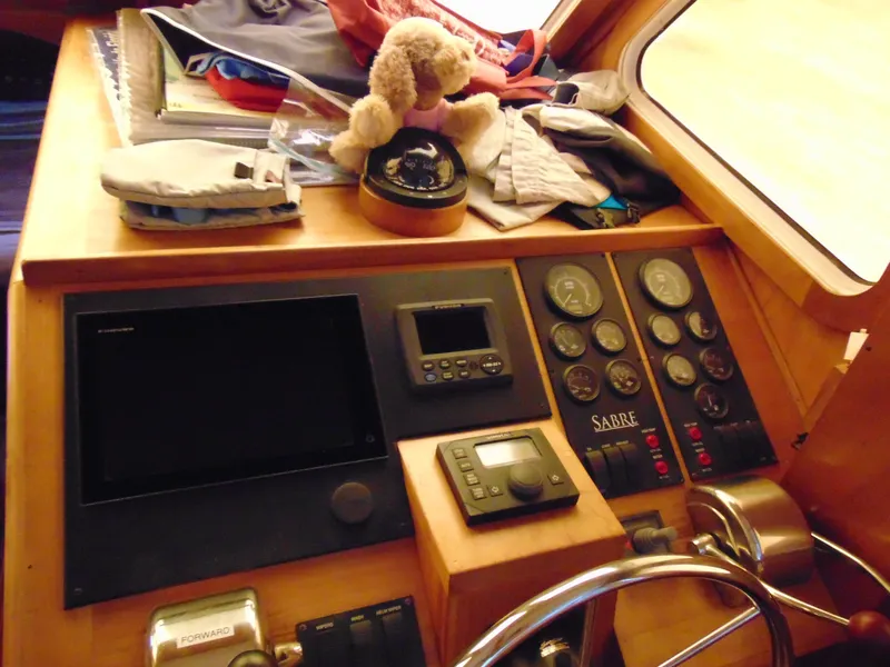 Slide: The Image of 2004 Sabre 36 Flybridge helm with navigation instruments and plush toy. - 15