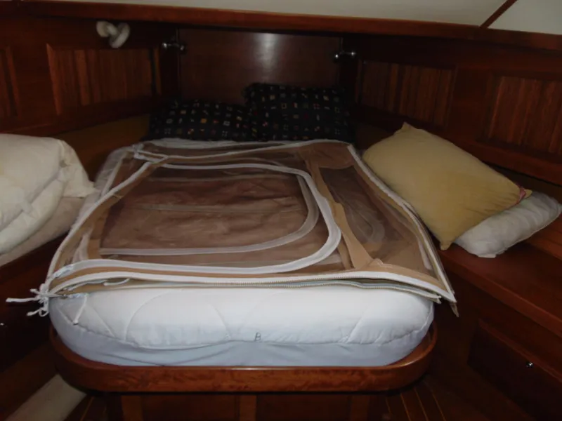 Slide: The Image of 2004 Sabre 36 Flybridge cabin with bed and wooden interior. - 21