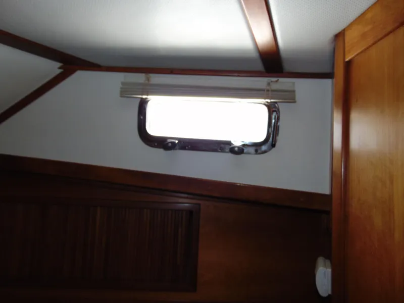 Slide: The Image of Interior cabin window of 2004 Sabre 36 Flybridge boat with wooden trim. - 23