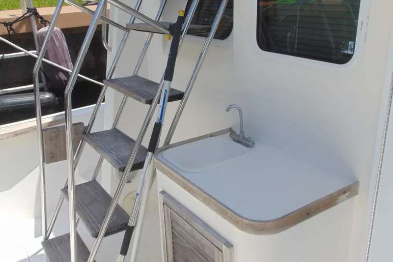Slide: The Image of 2004 Sabre 36 Flybridge boat with exterior sink and ladder. - 3