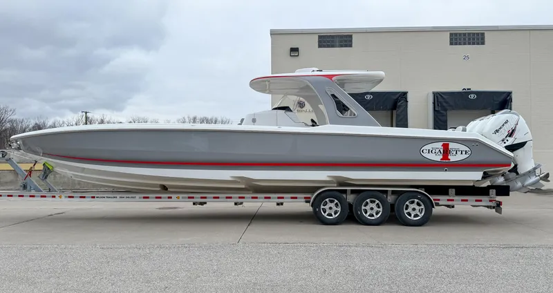 The Image of 2018 Cigarette 39 GTS boat on trailer, sleek design, gray and red accents. - 0