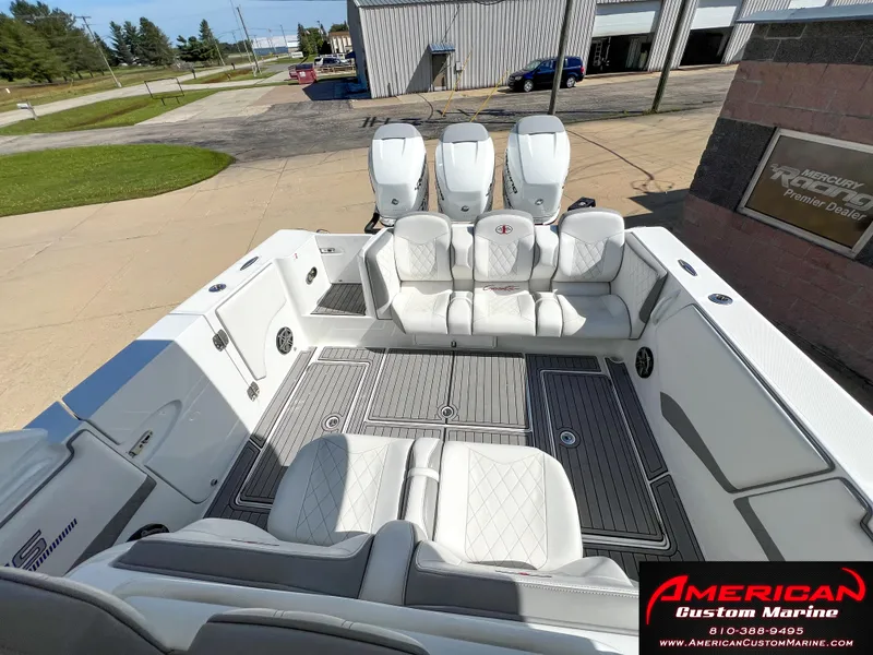 Slide: The Image of 2018 Cigarette 39 GTS boat interior with white seating and triple engines at American Custom Marine. - 11