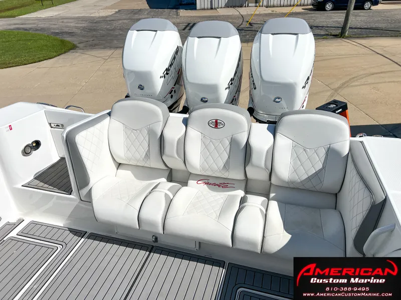 Slide: The Image of 2018 Cigarette 39 GTS boat with white seating and triple outboard engines. - 12