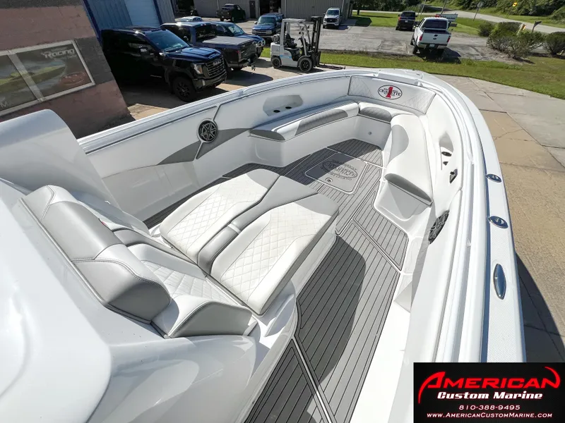 Slide: The Image of 2018 Cigarette 39 GTS boat interior with white seating and American Custom Marine branding. - 22