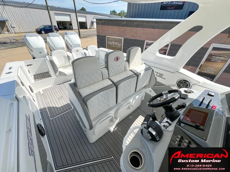 Slide: The Image of 2018 Cigarette 39 GTS boat interior with luxury seating and modern controls at American Custom Marine. - 24