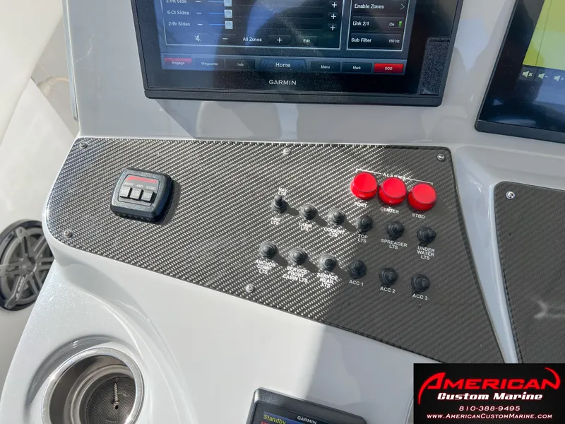 Slide: The Image of Control panel of 2018 Cigarette 39 GTS boat with carbon fiber finish and navigation screens. - 25