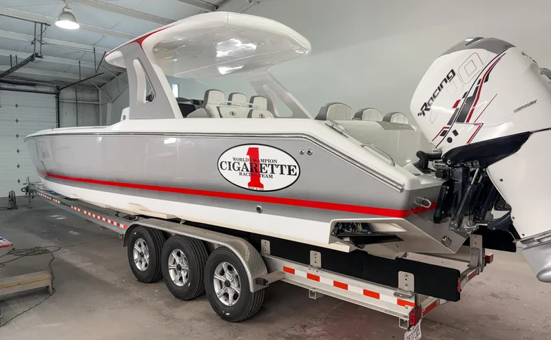 Slide: The Image of 2018 Cigarette 39 GTS boat on trailer in garage, featuring sleek design and powerful engine. - 4