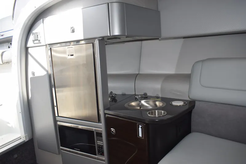 Slide: The Image of 2015 Formula 310 Sun Sport interior kitchenette with stainless steel appliances and modern design. - 14