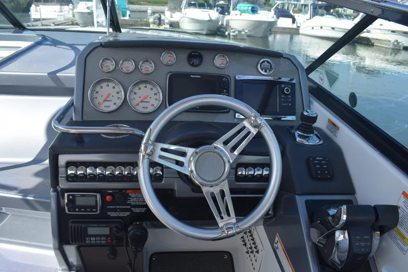 Slide: The Image of 2015 Formula 310 Sun Sport boat dashboard with steering wheel and gauges. - 4