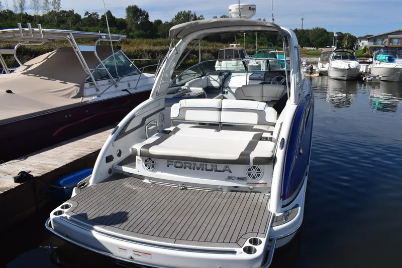 Slide: The Image of 2015 Formula 310 Sun Sport boat docked at a marina. - 5
