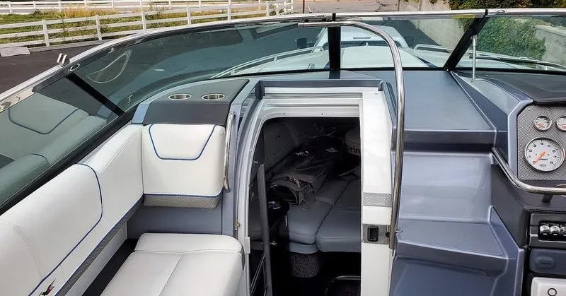 Slide: The Image of 2015 Formula 310 Sun Sport boat interior with white seating and cabin entrance. - 6