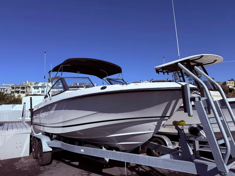 Slide: The Image of 2025 Boston Whaler 210 Vantage boat on trailer under clear blue sky. - 1