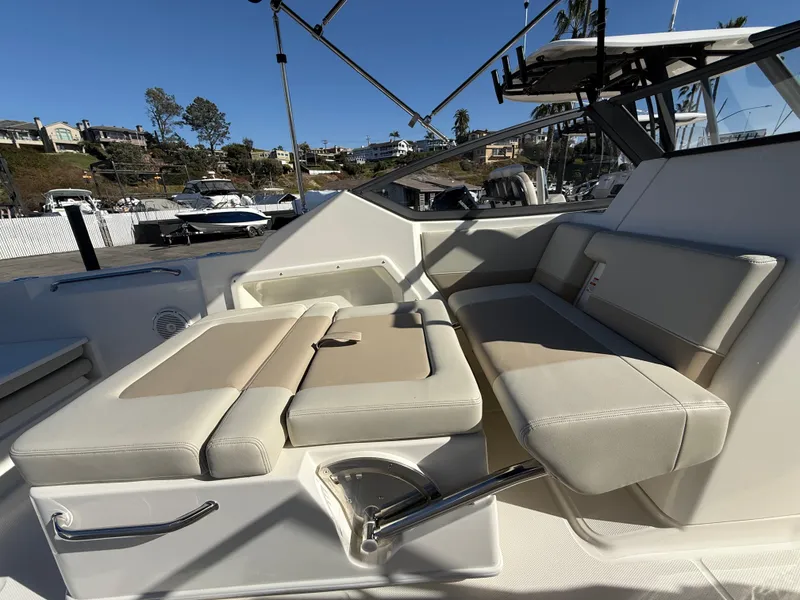 Slide: The Image of 2025 Boston Whaler 210 Vantage boat interior with beige seating and modern design. - 10
