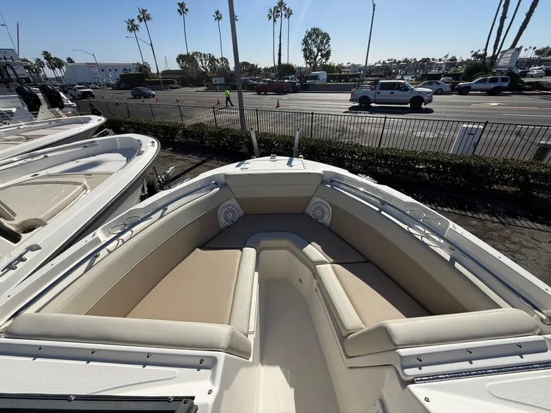 Slide: The Image of 2025 Boston Whaler 210 Vantage boat with spacious seating, parked outdoors. - 16