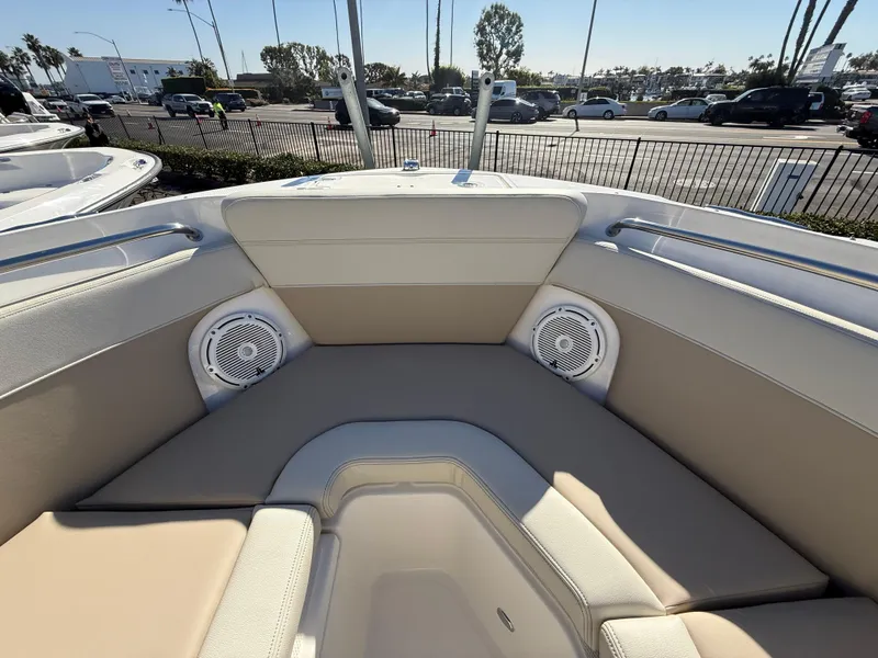 Slide: The Image of 2025 Boston Whaler 210 Vantage boat interior with beige seating and built-in speakers. - 19