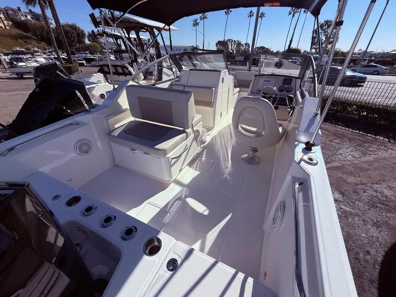 Slide: The Image of 2025 Boston Whaler 210 Vantage boat interior with seating and steering console. - 5