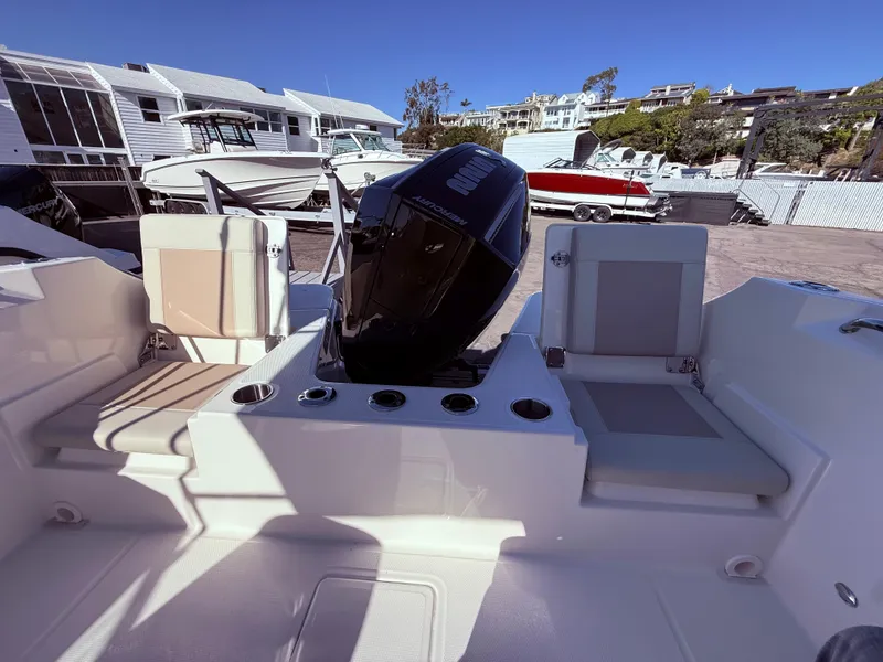 Slide: The Image of 2025 Boston Whaler 210 Vantage boat interior with seating and engine view. - 6