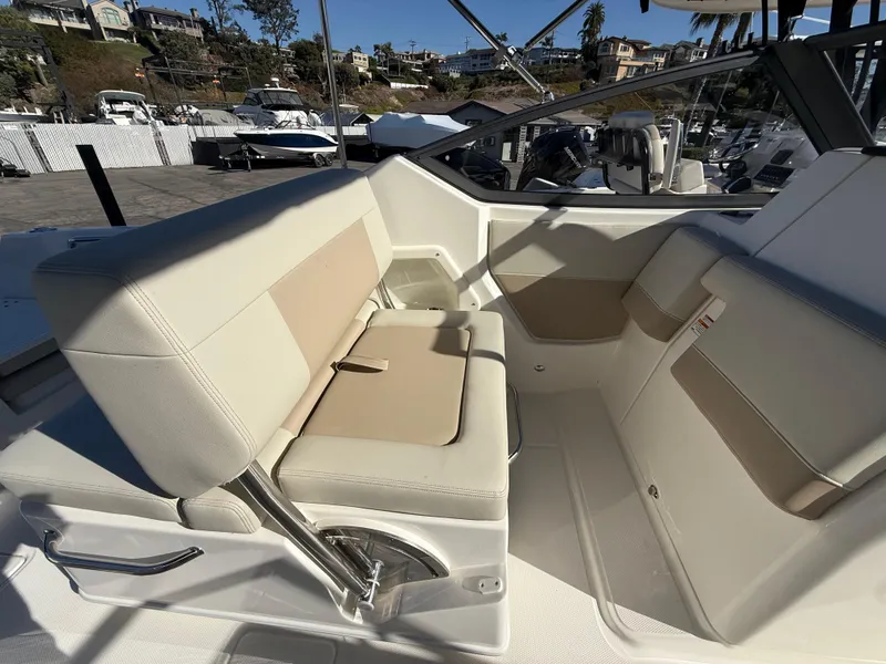 Slide: The Image of 2025 Boston Whaler 210 Vantage boat interior with beige seating and modern design. - 9