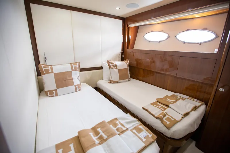 Slide: The Image of Luxurious twin cabin in 2011 Princess 85 Motor Yacht with elegant bedding and porthole windows. - 24