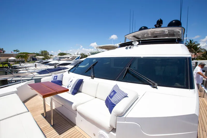 Slide: The Image of Luxurious 2011 Princess 85 Motor Yacht with outdoor seating and cushions, docked under clear skies. - 28