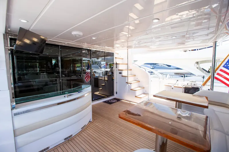 Slide: The Image of Luxurious 2011 Princess 85 Motor Yacht deck with seating, TV, and staircase. - 49