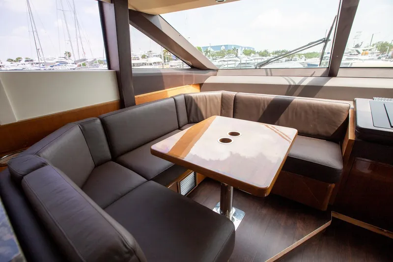Slide: The Image of Luxurious seating area on 2011 Princess 85 Motor Yacht with elegant wood table. - 9