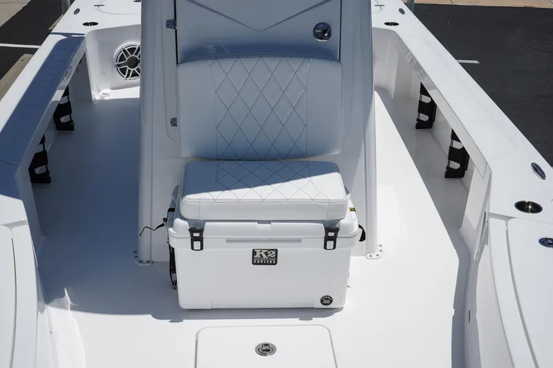 Slide: The Image of 2025 Blazer 2550 GTS boat interior with cushioned seating and K2 cooler. - 16