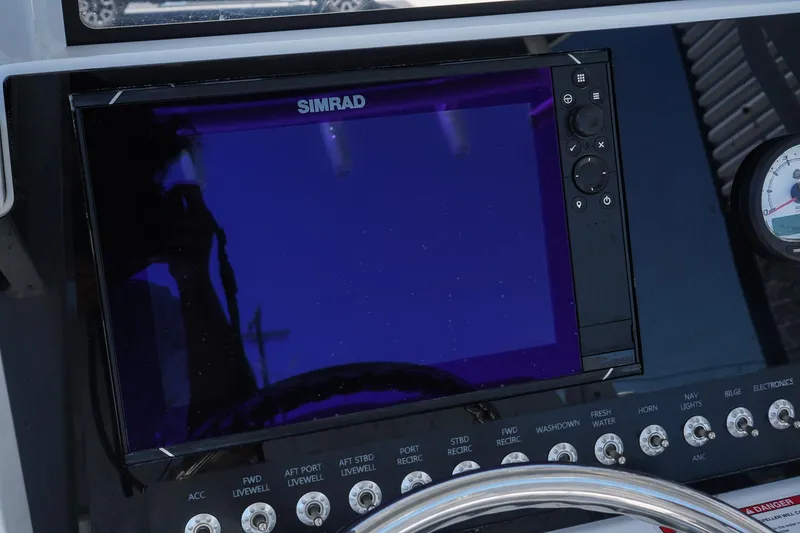 Slide: The Image of Simrad display on 2025 Blazer 2550 GTS boat dashboard with control buttons. - 22