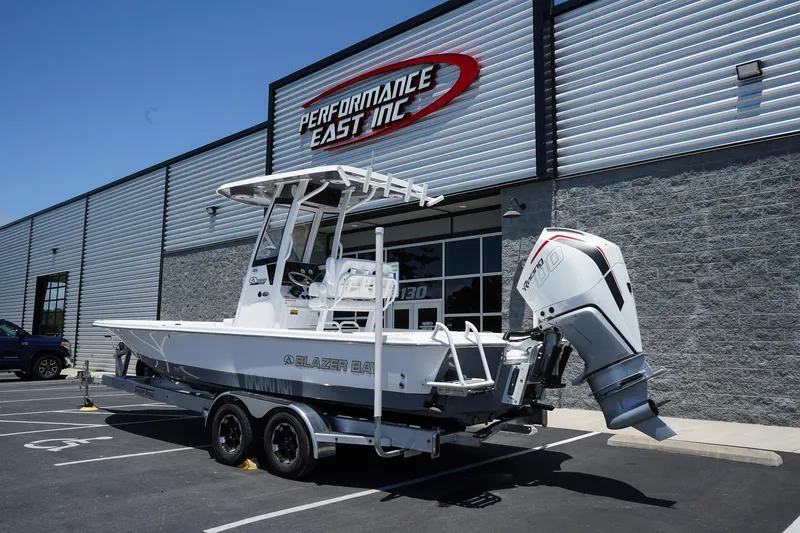 Slide: The Image of 2025 Blazer 2550 GTS boat on trailer outside Performance East Inc. building. - 3