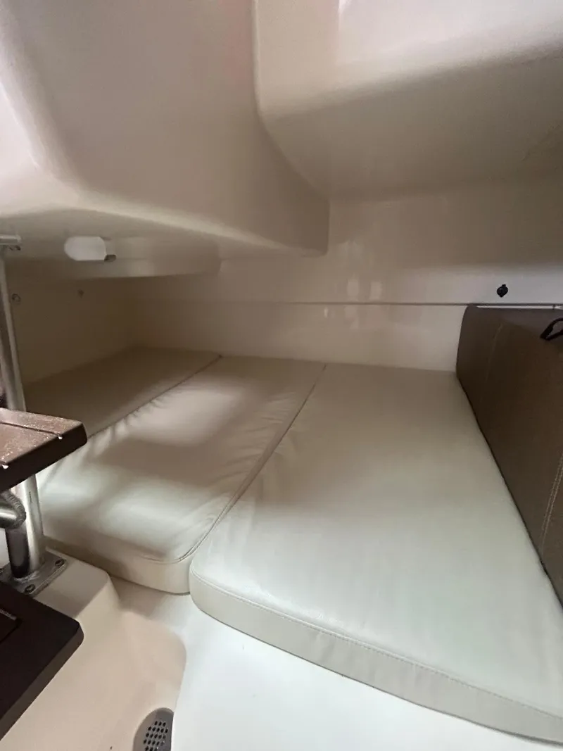 Slide: The Image of 2023 Boston Whaler 285 Conquest cabin interior with cushioned seating. - 5