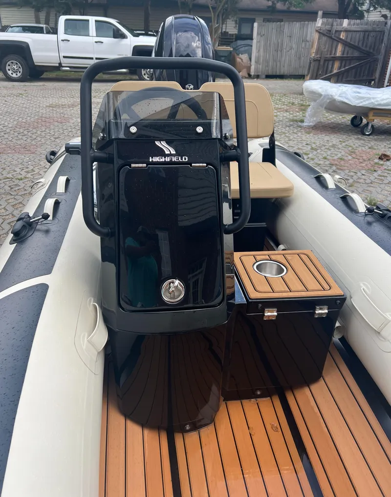 Slide: The Image of 2024 Highfield Classic 380 GT boat with teak flooring and black console. - 2