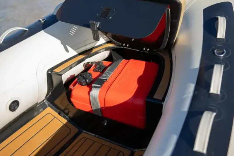 Slide: The Image of 2024 Highfield Classic 380 GT boat with open storage compartment and red fuel tank. - 6