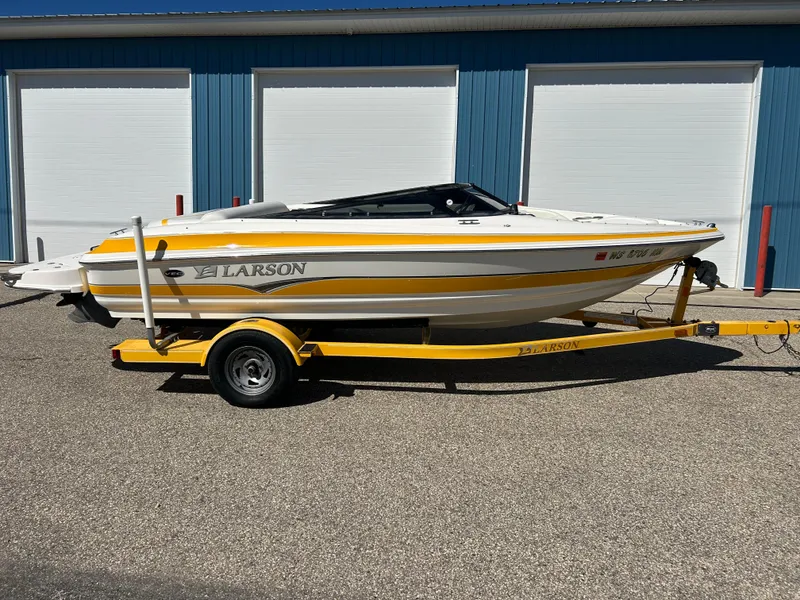 Slide: The Image of 2007 Larson 180SEI LX boat on a yellow trailer, parked outdoors. - 1