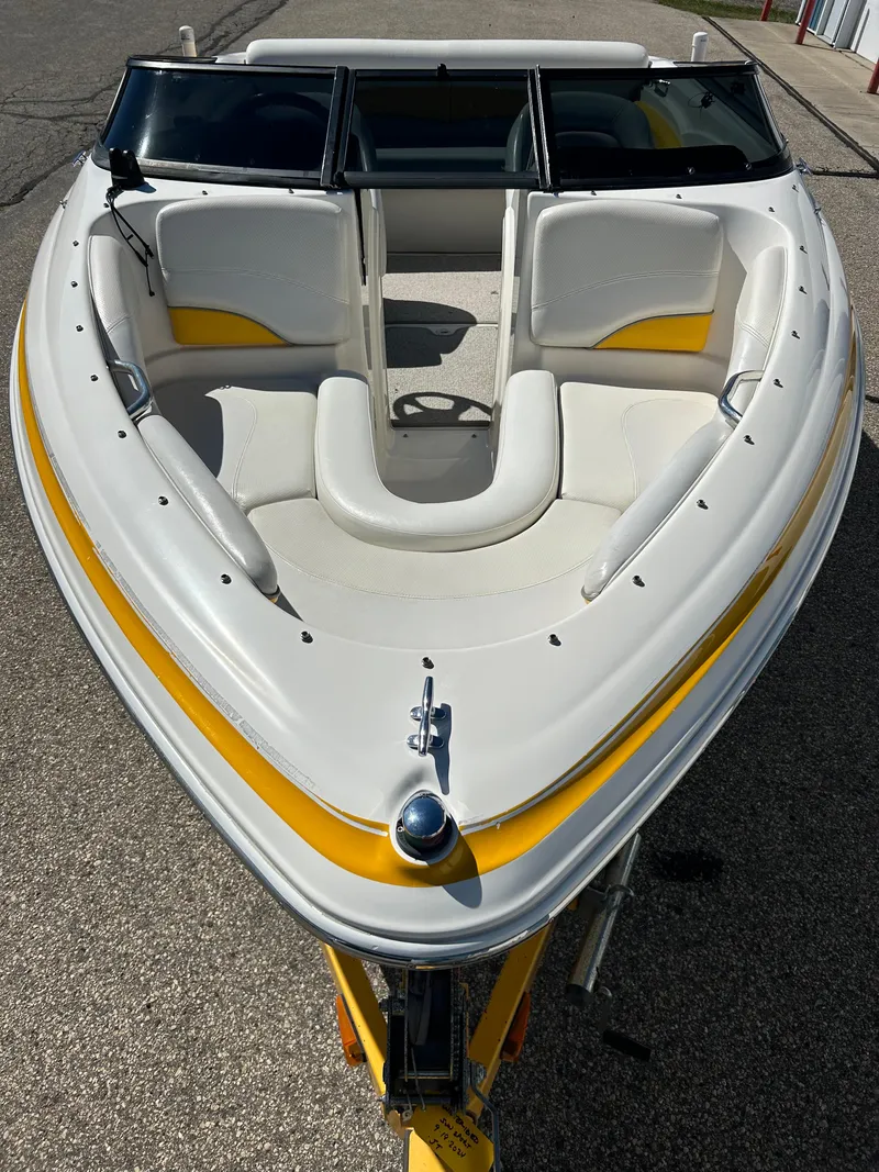Slide: The Image of 2007 Larson 180SEI LX boat with white and yellow interior, docked on a sunny day. - 5