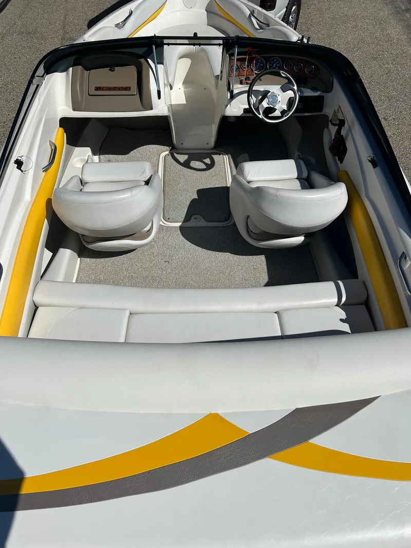 Slide: The Image of 2007 Larson 180SEI LX boat interior with white seating and yellow accents. - 6