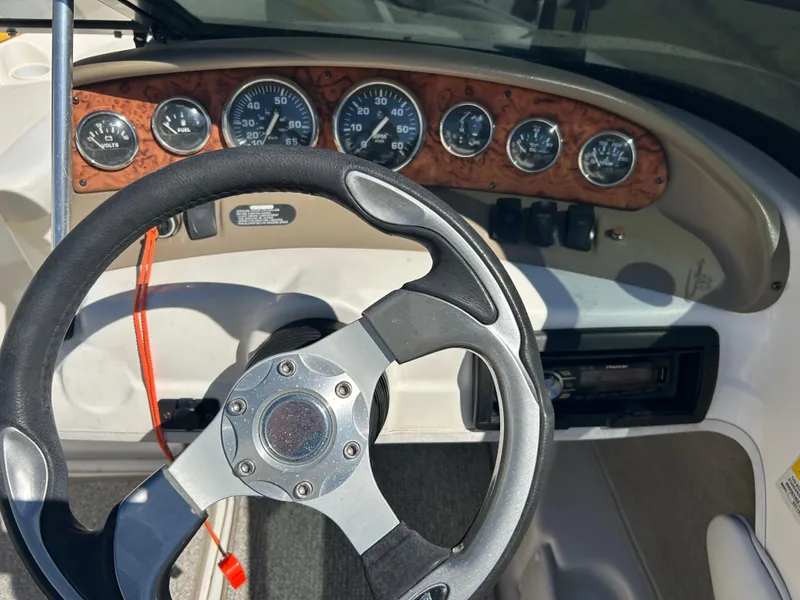 Slide: The Image of 2007 Larson 180SEI LX boat dashboard with steering wheel and gauges. - 7