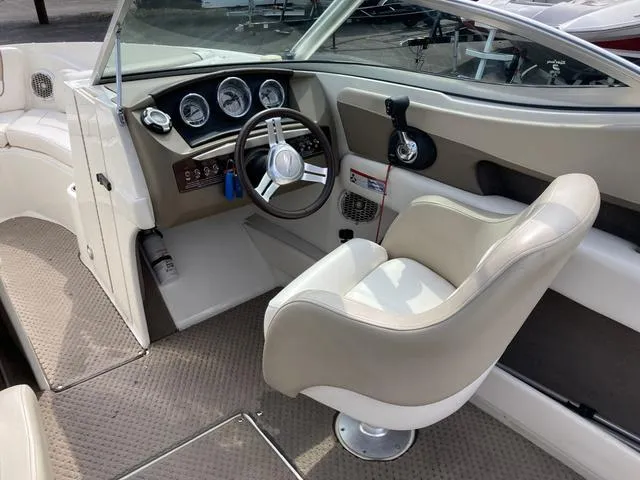 Slide: The Image of 2011 Sea Ray 230 SLX boat interior with captain's chair and dashboard. - 10