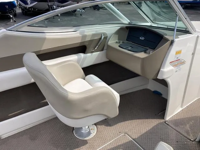 Slide: The Image of Interior cockpit of a 2011 Sea Ray 230 SLX boat with captain's chair. - 11